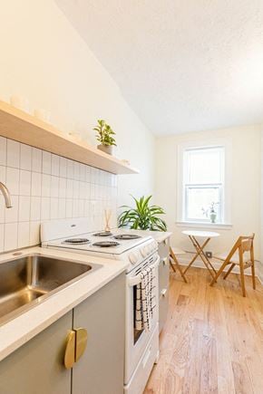 Detroit apartment for rent - a kitchen with a stove and a sink and a window