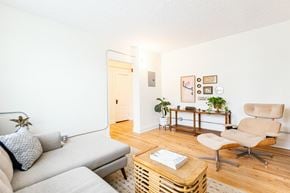 Detroit apartment for rent - a living room with a couch and a chair and a table