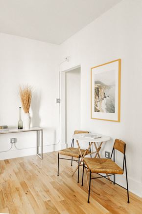 Detroit apartment for rent - a dining room with a table and chairs and a painting on the wall
