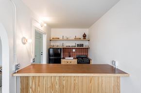 Detroit apartment for rent - a kitchen with a wooden counter top and a black refrigerator