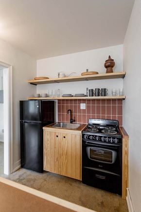 Detroit apartment for rent - a small kitchen with a stove refrigerator and sink