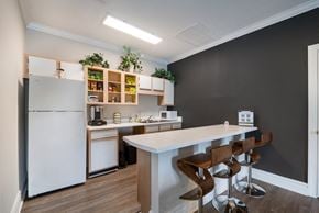 Athens apartment for rent - A kitchen with a white counter and bar stools.