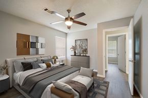 Athens apartment for rent - A bedroom with a large bed and a ceiling fan.