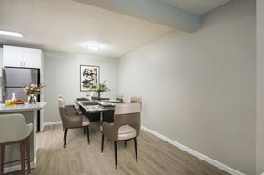 Athens apartment for rent - A dining room with a table set for two and chairs around it.