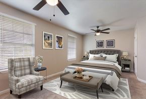 Gulfport apartment for rent - a bedroom with a bed and a ceiling fan