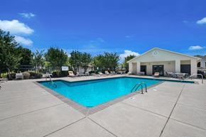 Athens apartment for rent - A large outdoor swimming pool with a building in the background.