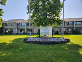 Crookston apartment for rent - A sign for Nimienis stands in front of a building.