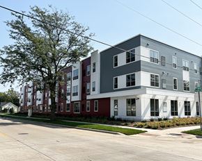 Austin apartment for rent - A row of modern townhouses with a tree in front of the first one.