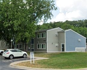 St. Charles apartment for rent - a gray building with a white car parked in front of it
