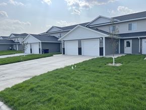 Belle Plaine townhouse for rent - A residential area with houses and a tree.