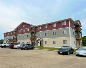 Jackson apartment for rent - A parking lot in front of a multi-story apartment building.