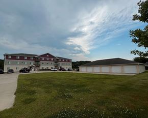 Jackson apartment for rent - A large building with a red roof is surrounded by a grassy field.