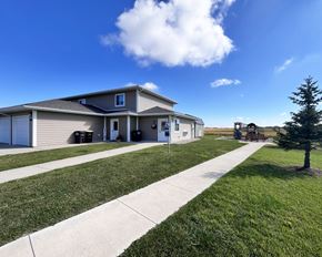 Eagle Lake townhouse for rent - A house with a well-maintained lawn and a clear blue sky.