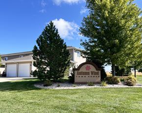 Eagle Lake townhouse for rent - A sign for Autumn Wind Town Homes is in front of a house.