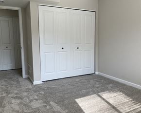 Belle Plaine townhouse for rent - a bedroom with two closets and a carpeted floor