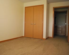 Mankato apartment for rent - a bedroom with a closet and a door to a hallway