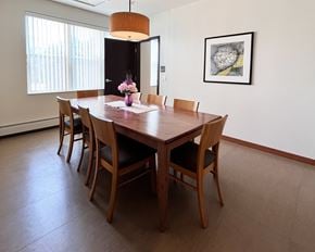 Rochester apartment for rent - A dining room with a wooden table and chairs.