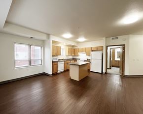 Mankato apartment for rent - A kitchen with wooden floors and white appliances.