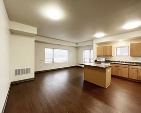 Mankato apartment for rent - A kitchen with wooden floors and white walls.