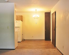Westbrook apartment for rent - an empty living room with a refrigerator and a door