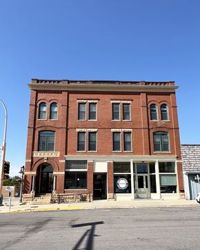 Olivia apartment for rent - an old brick building on the corner of a city street