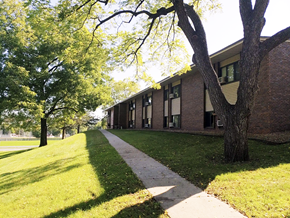 Red Wing apartment for rent - A tree is in front of a building.