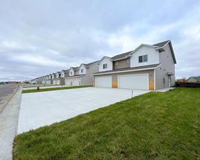 Mankato townhouse for rent - a house with a driveway and a row of garage doors
