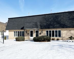 Mankato townhouse for rent - A building with a black roof and white doors and windows.