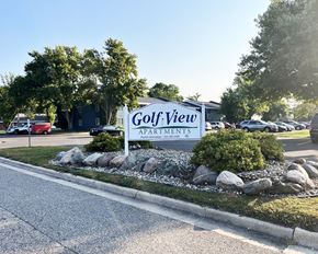 Cokato apartment for rent - a sign for golf view apartments in front of a parking lot