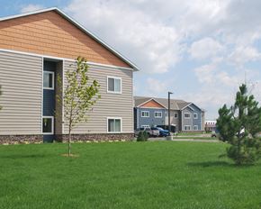 Lake City apartment for rent - a green lawn in front of a house