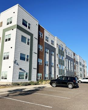 Forest Lake apartment for rent - a car parked in front of an apartment building