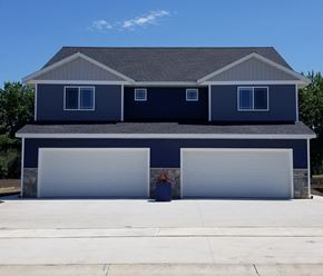 Mankato townhouse for rent - a house with two garage doors in front of it