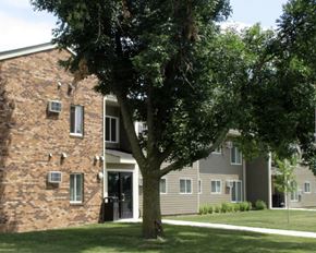 Worthington apartment for rent - an apartment building with a tree in the yard