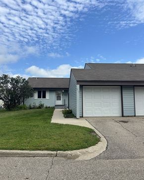 Litchfield townhouse for rent - A house with a grey roof and a white garage door.