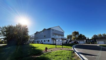 Eagle Lake townhouse for rent - A large white building with the word "Circulation" on it is surrounded by a grassy area and trees.
