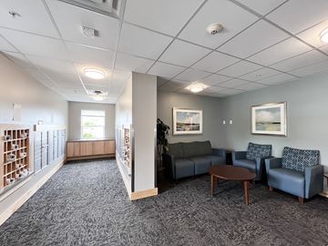 Shakopee apartment for rent - A living room with a grey carpet and a grey couch.