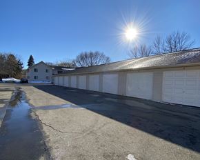 Willmar apartment for rent - a white garage with the sun shining above it