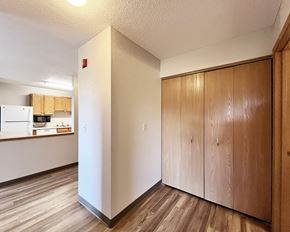 New Ulm apartment for rent - A kitchen area with wooden floors and cabinets.