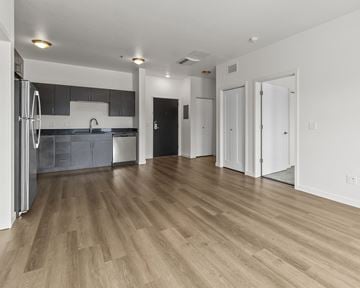 Luverne apartment for rent - the living room and kitchen of an apartment with wood flooring