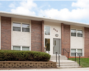 Northfield apartment for rent - A brick building with a grey door and windows.