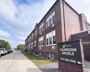 Hastings townhouse for rent - A brick building with a sign that says Guardian Angels.