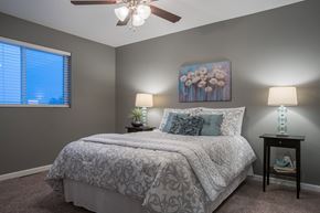 Eagle Lake townhouse for rent - a bedroom with a bed and a ceiling fan