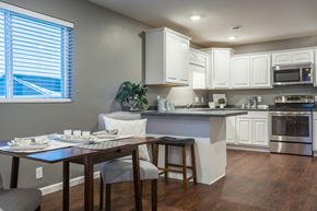 Eagle Lake townhouse for rent - an open kitchen and dining area with a table and chairs