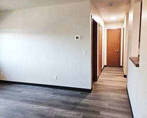 Alexandria apartment for rent - A hallway with a wooden door at the end.