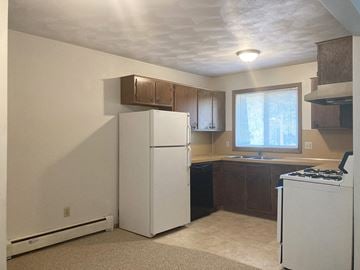 St. Peter apartment for rent - a kitchen with a refrigerator and a stove and a window