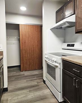 Alexandria apartment for rent - A kitchen with a white oven and wooden cabinets.