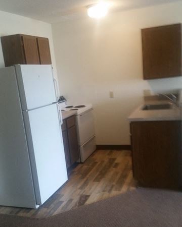 Winthrop apartment for rent - an empty kitchen with a refrigerator and a stove