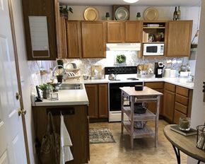 Montevideo townhouse for rent - a kitchen with wooden cabinets and a white counter top
