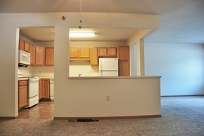 St. Peter apartment for rent - A kitchen with wooden cabinets and a white refrigerator.