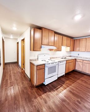 Shakopee apartment for rent - A kitchen with wooden floors and white appliances.